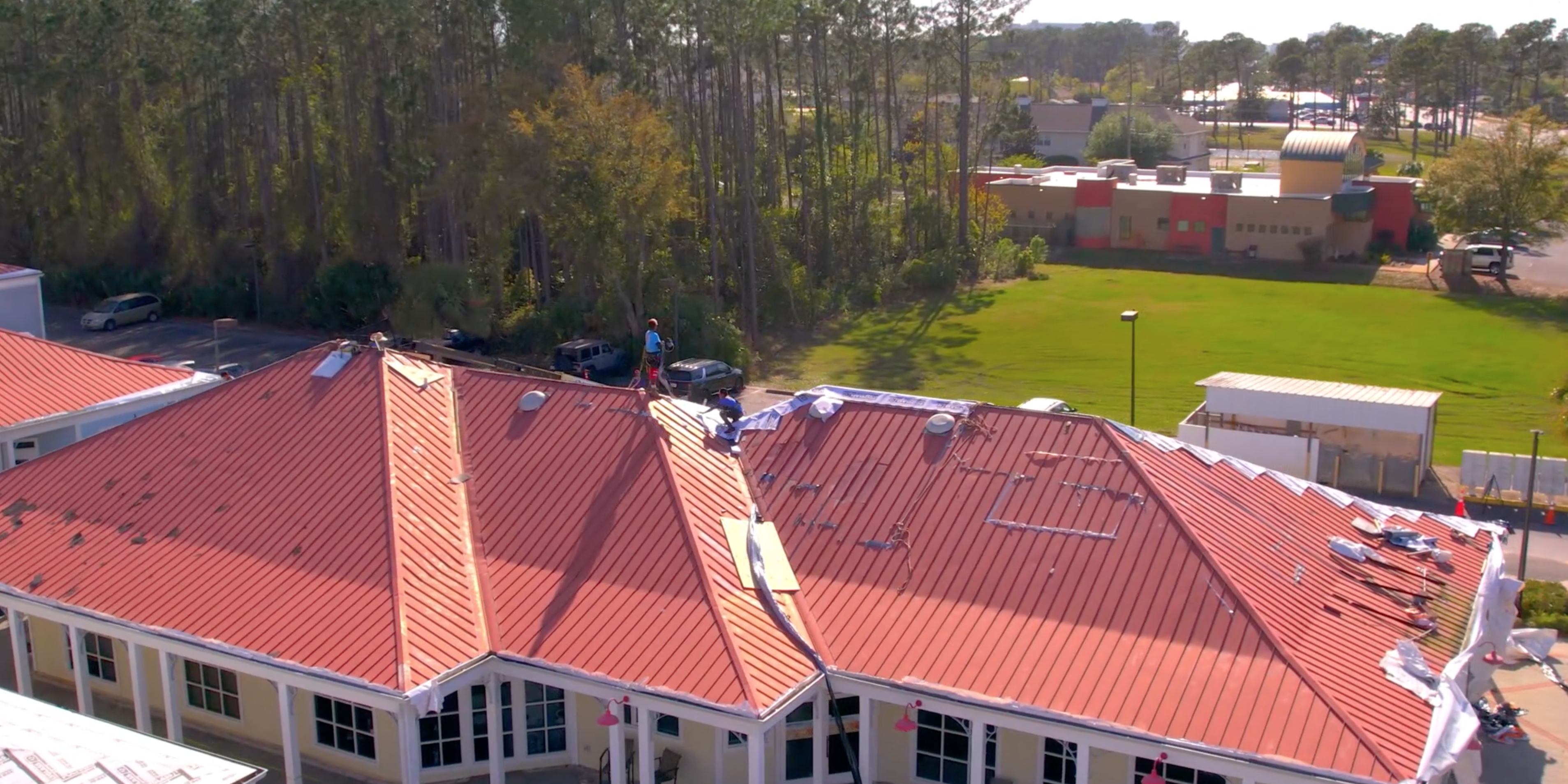 Hammer Down Roofing installing new roof on Promanade Mall in Panama City Florida