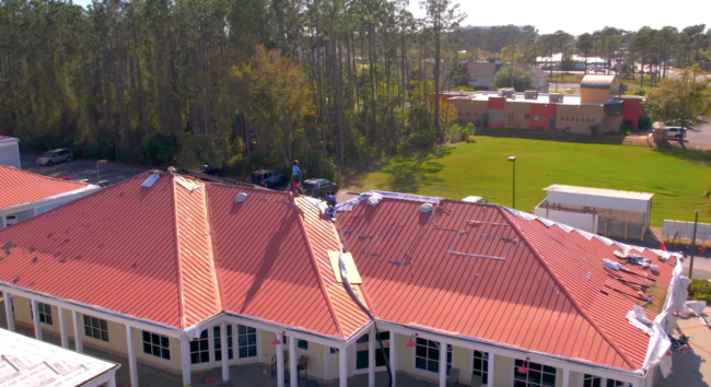 Hammer Down Roofing installing new roof on Promanade Mall in Panama City Florida